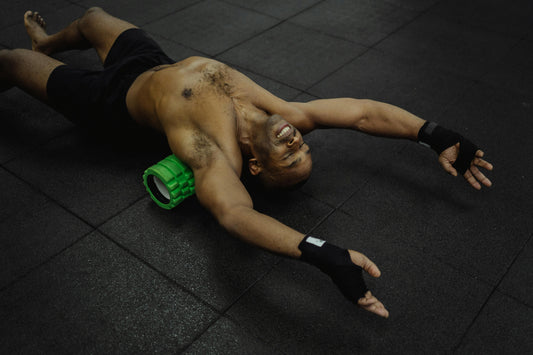 Man using foam roller on back for muscle recovery